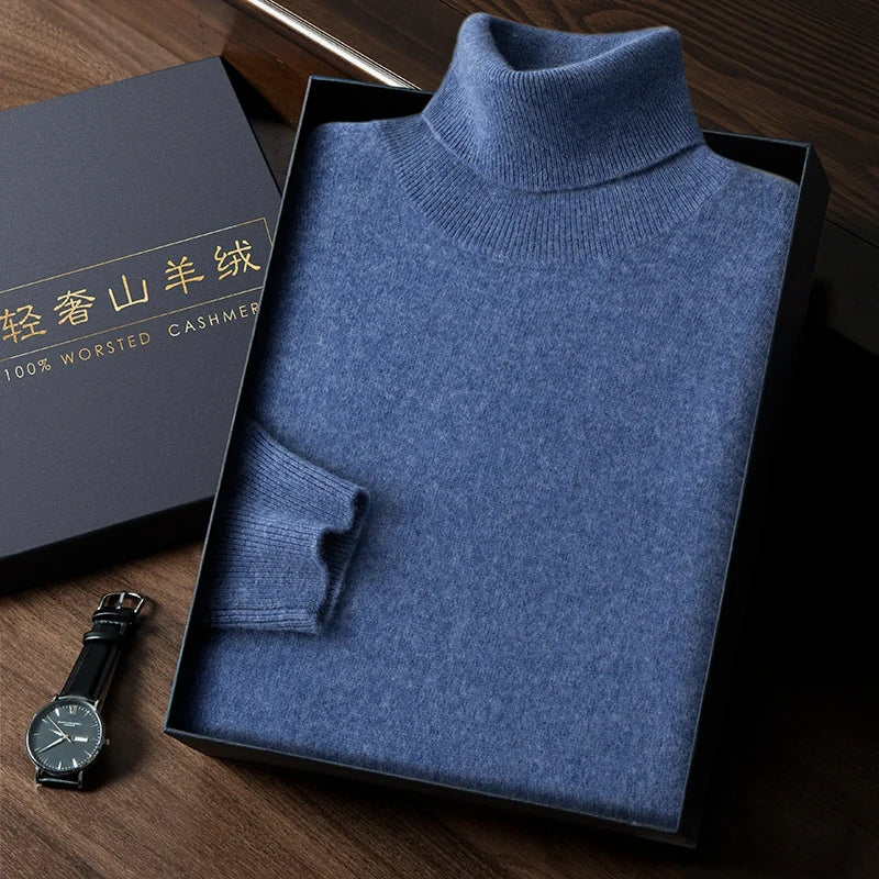 Blue turtleneck sweater in a box with a watch on a wooden surface