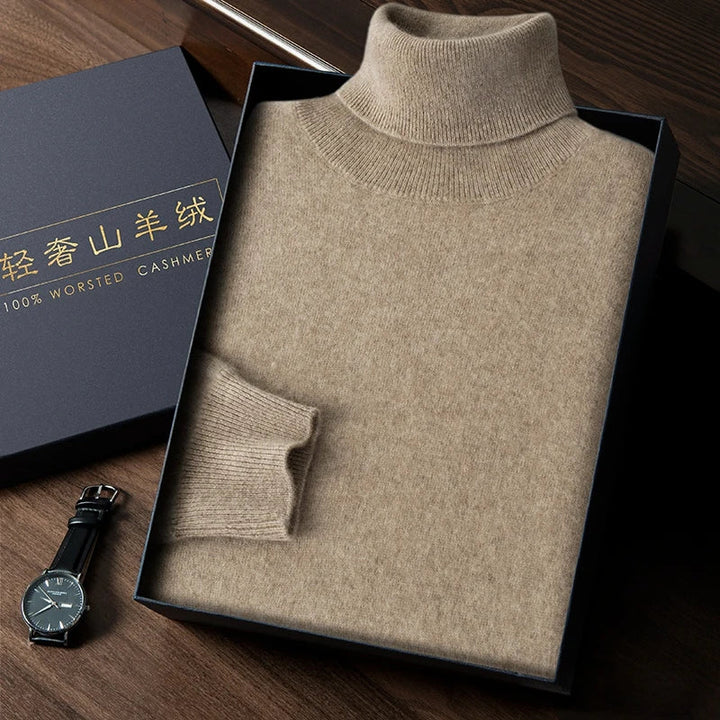 Folded beige turtleneck sweater in a box with a watch on a wooden surface