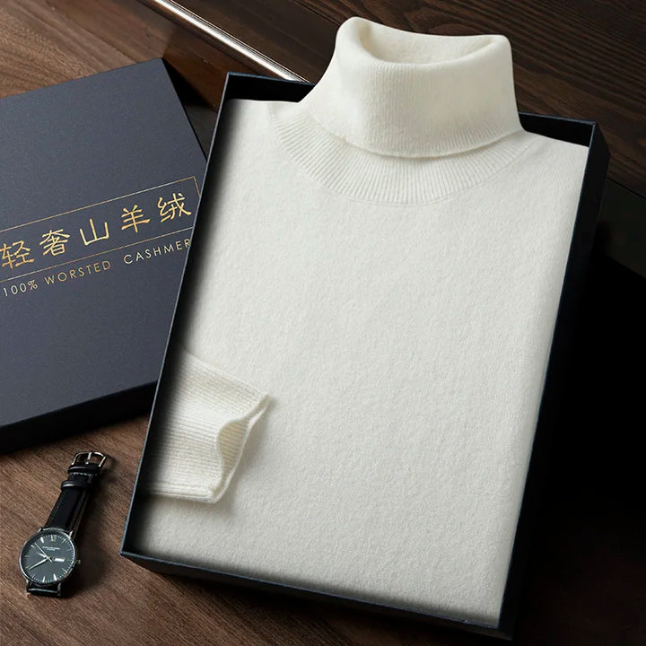 White turtleneck sweater in a box with a watch on a wooden surface