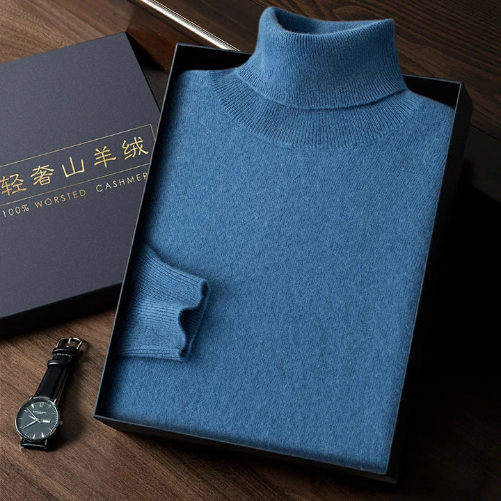 Blue turtleneck sweater in a box with a watch on a wooden surface