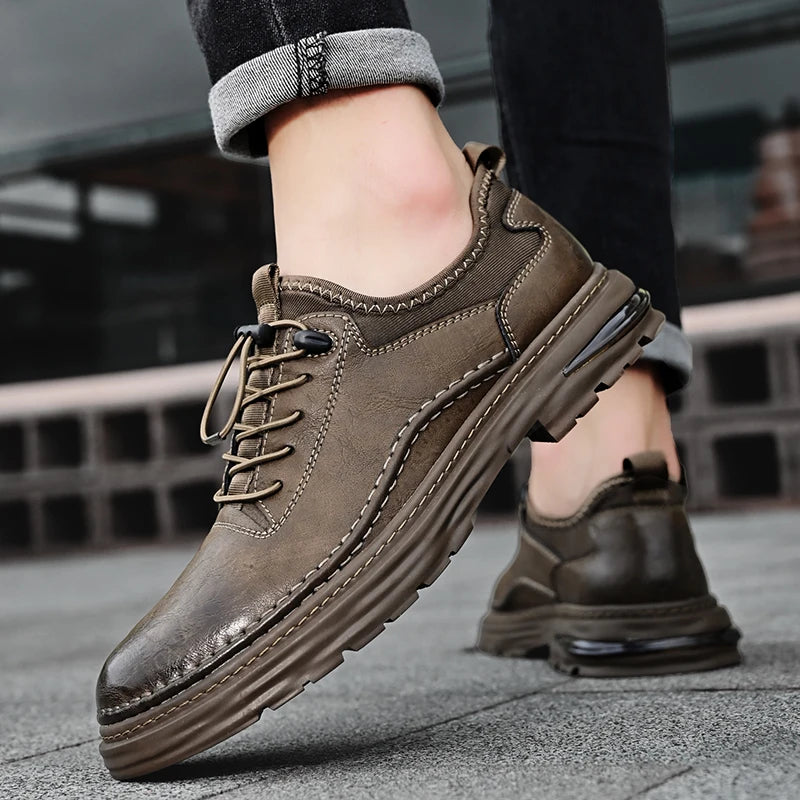Brown leather shoes worn on a blurred urban background