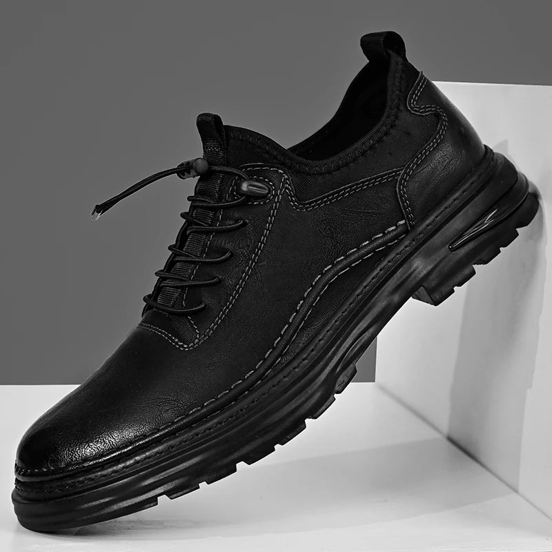 Black leather shoe on a white platform with a gray background