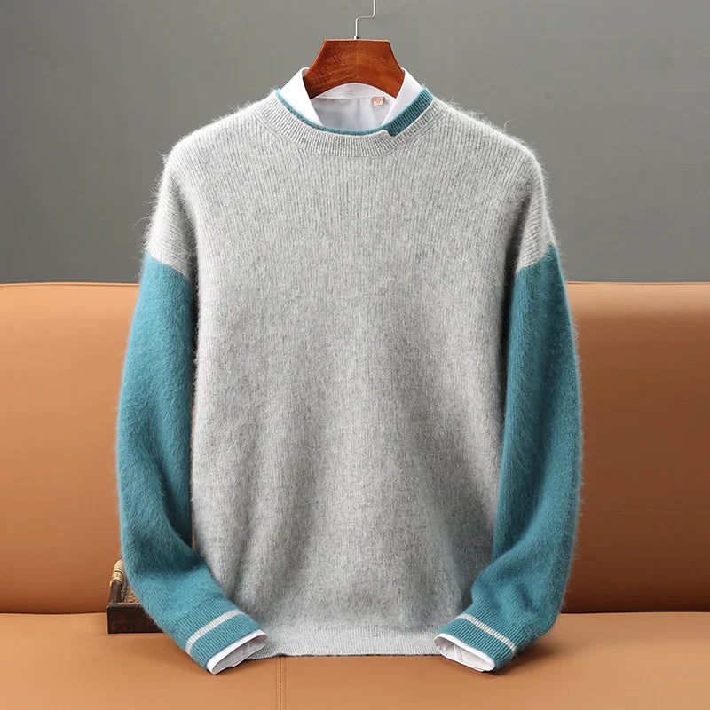 Gray sweater with teal sleeves on a hanger against a gray background