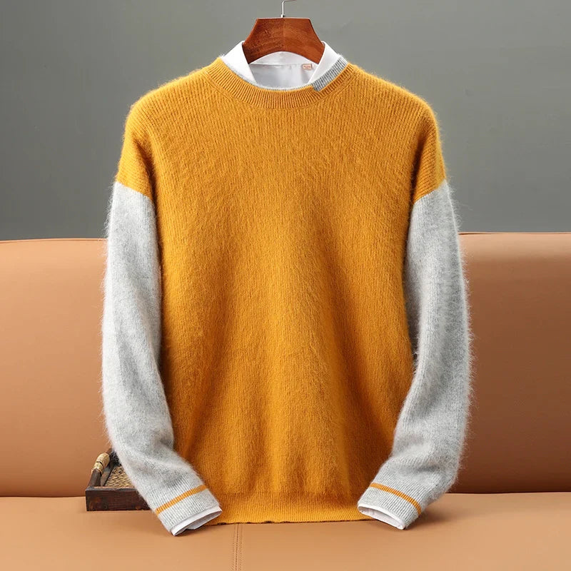 Yellow and gray sweater on a hanger against a neutral background
