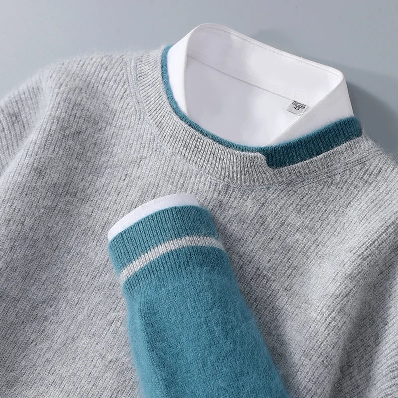 Gray sweater with teal sleeves and collar on a gray background