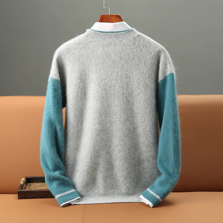 Gray sweater with teal sleeves on a hanger against a gray background
