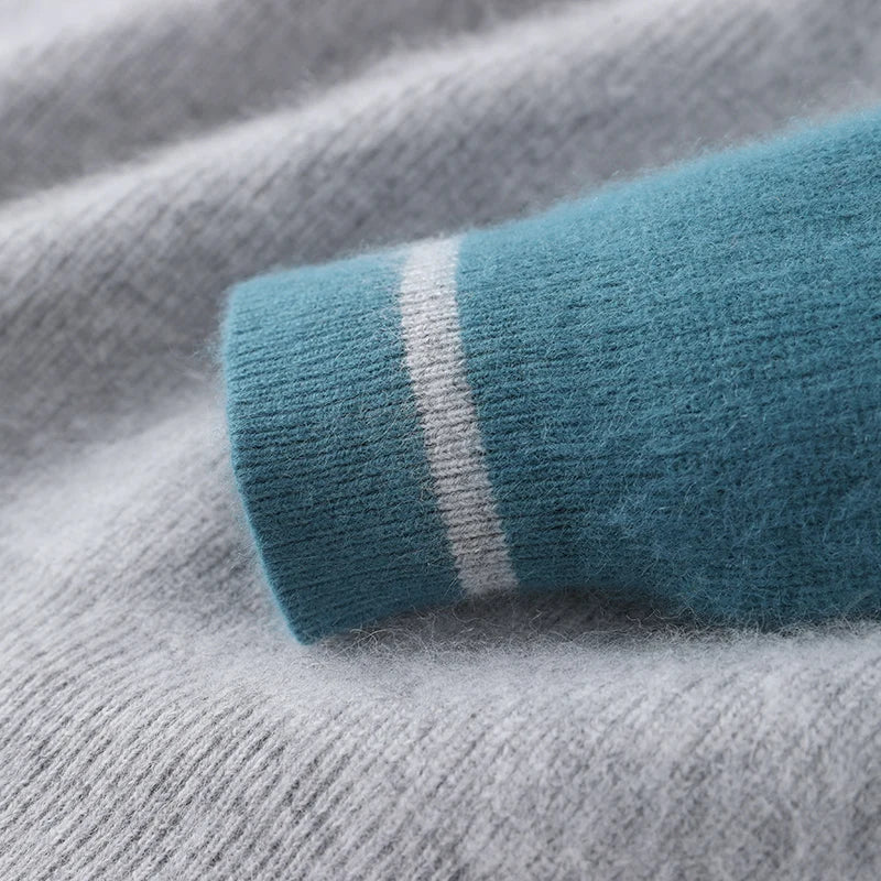 Close-up of a teal sock with white stripe on gray fabric