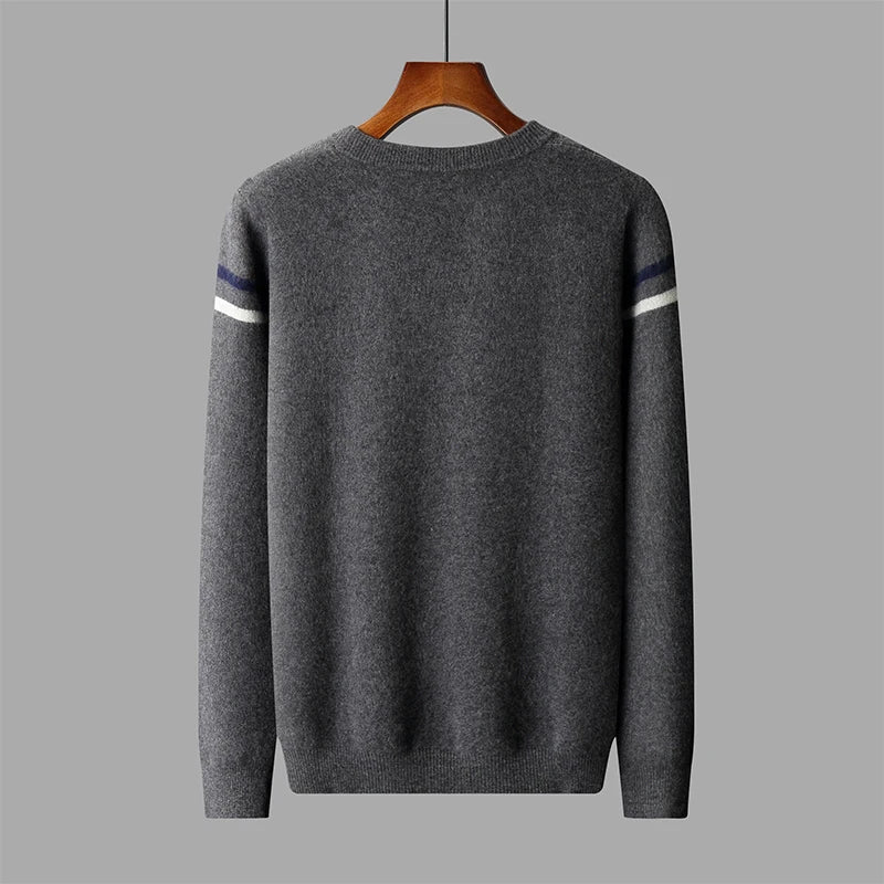 Gray sweater with white and blue stripes on sleeves on a hanger against a gray background