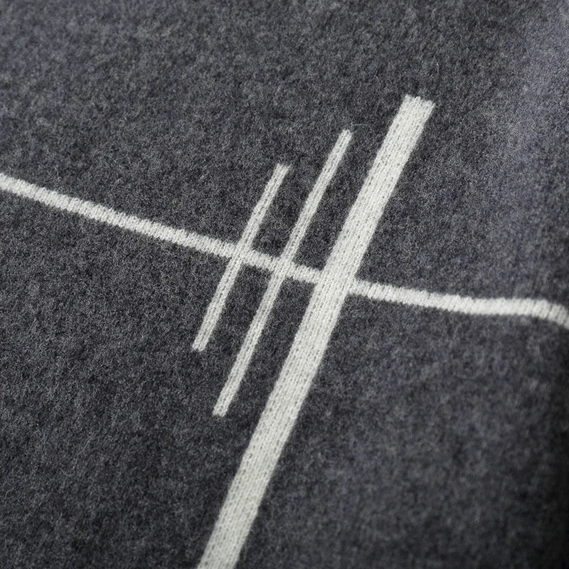 Close-up of a textured dark surface with a white geometric design.