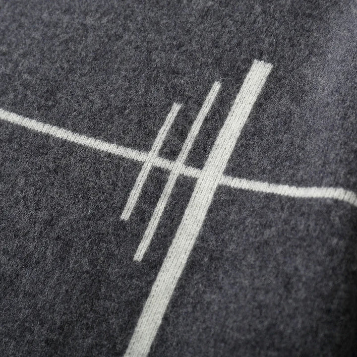 Close-up of a textured dark surface with a white geometric design.