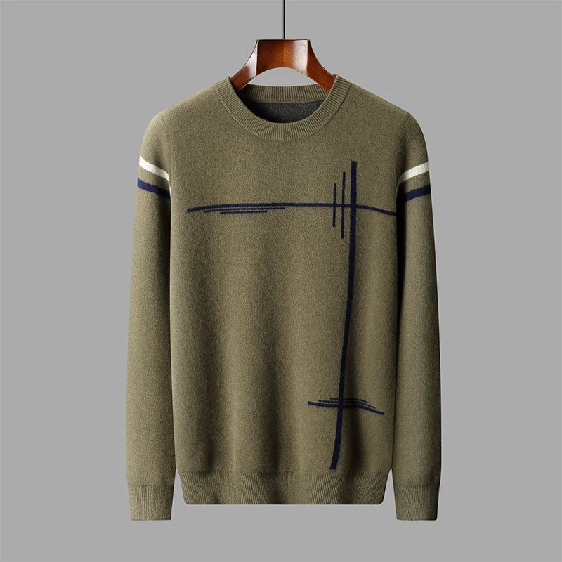 Green sweater with abstract black and white design on a gray background