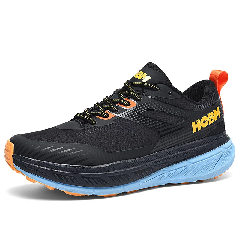 Black running shoe with orange accents and blue sole on a white background