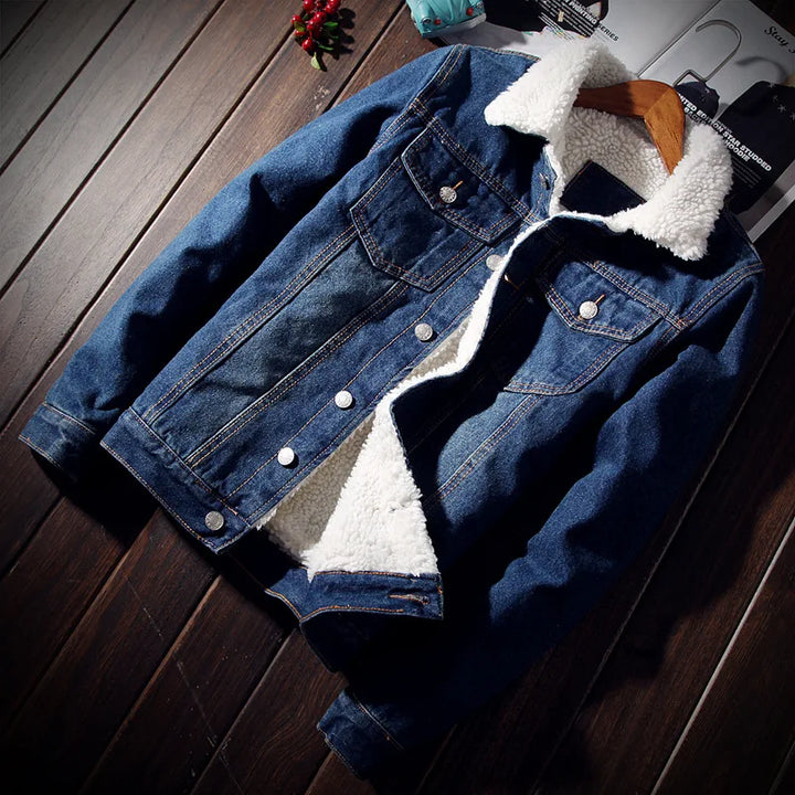Blue denim jacket with white sherpa lining on a wooden surface