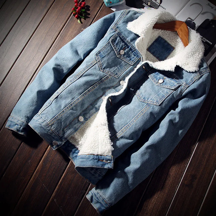 Denim jacket with white fur lining on a wooden surface