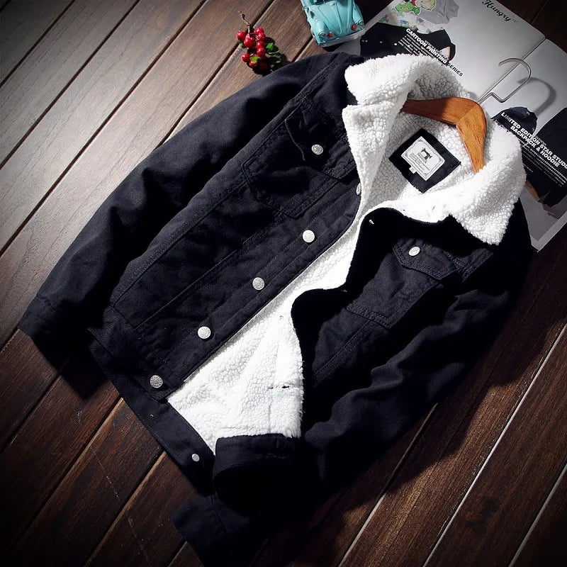 Black denim jacket with white fleece lining on a wooden surface
