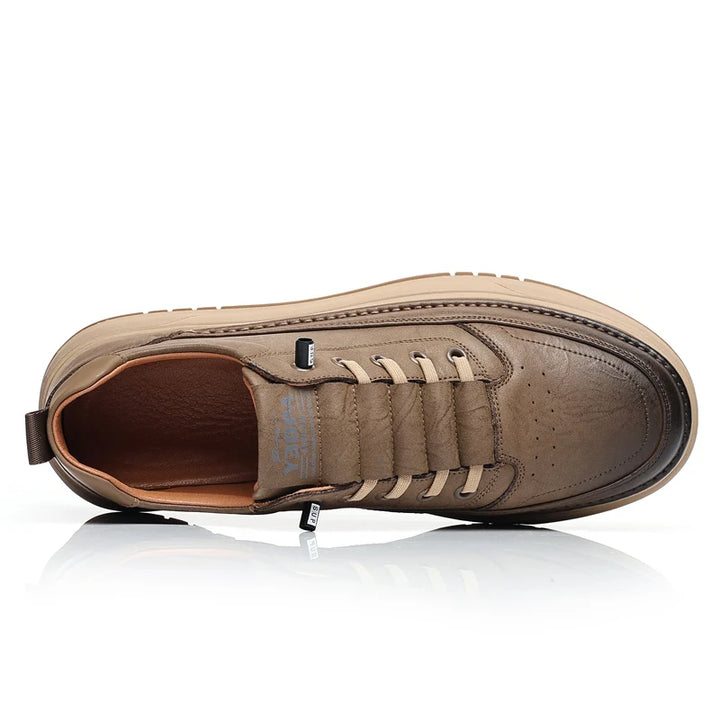 Brown leather shoe with white laces on a white background