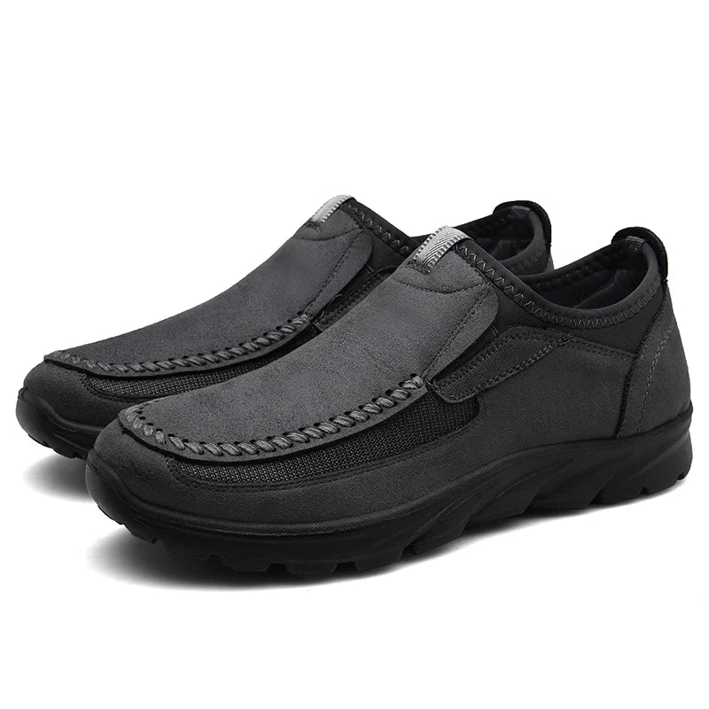 Pair of gray slip-on shoes on a white background