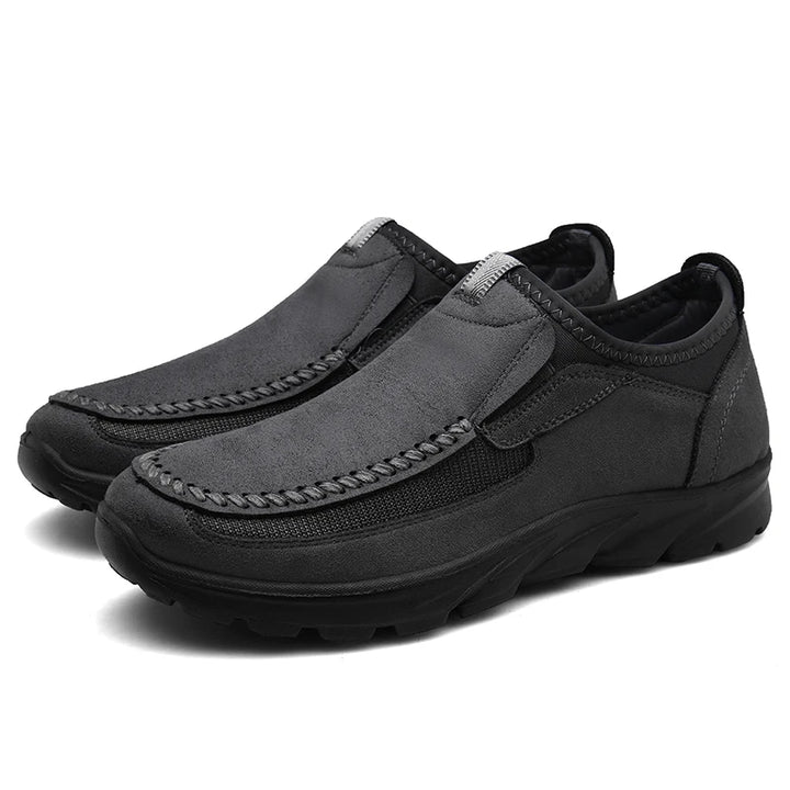 Pair of gray slip-on shoes on a white background