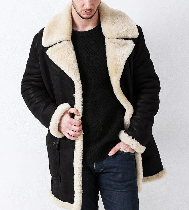 Man wearing a black coat with beige shearling collar and cuffs on a white background