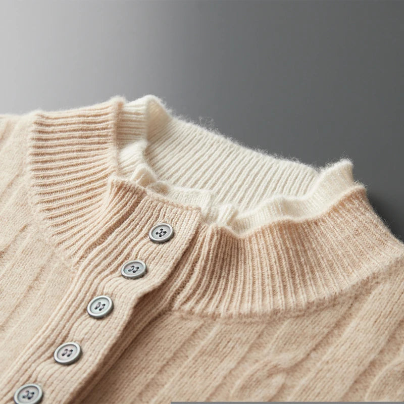 Close-up of a beige knitted sweater with buttons on a dark background