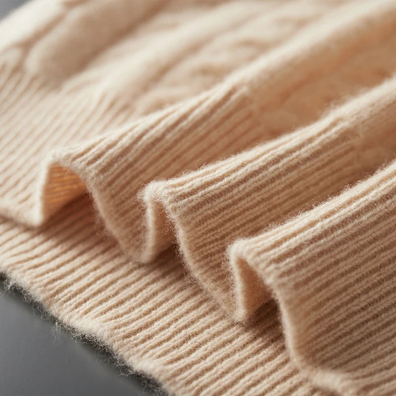 Close-up of beige knitted fabric on a dark surface
