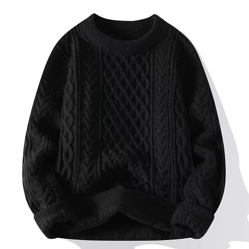 Black cable knit sweater on a white background