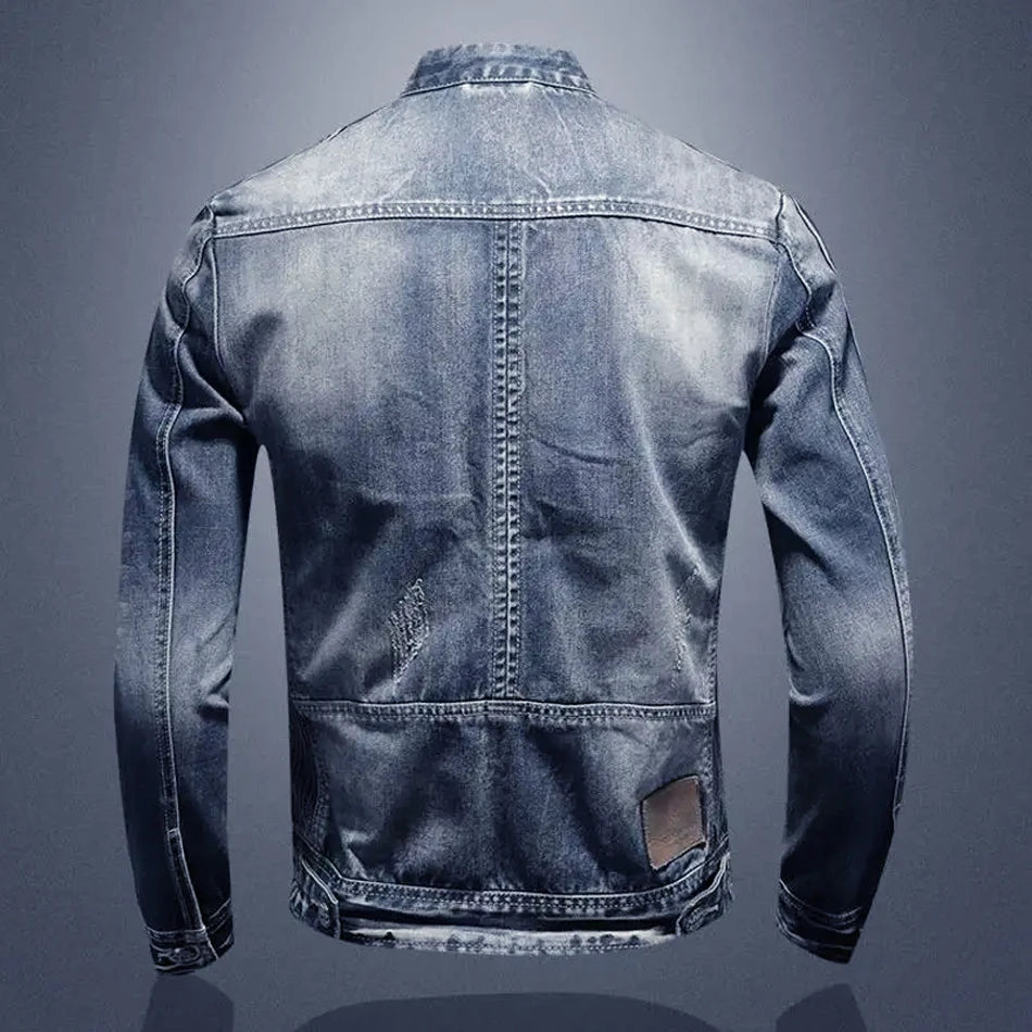 Back view of a blue denim jacket on a gray background