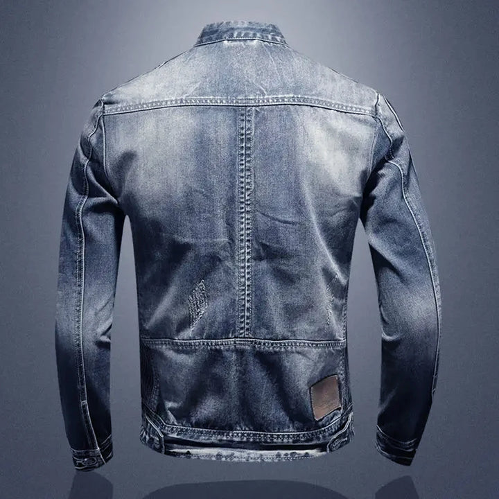 Back view of a blue denim jacket on a gray background