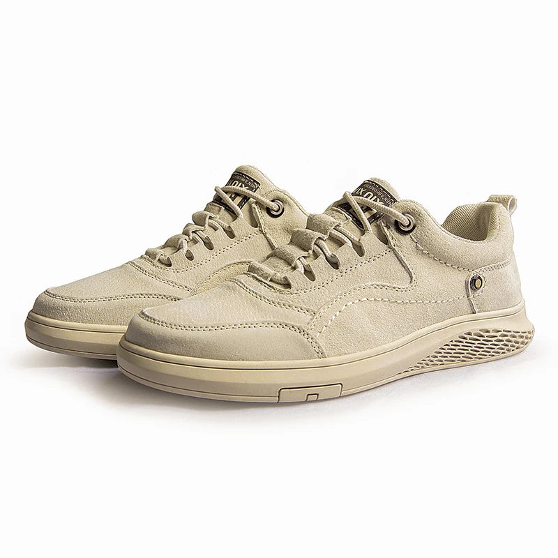 Pair of beige sneakers on a white background