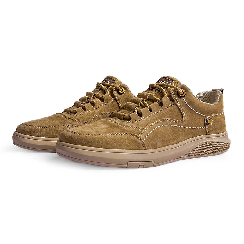 Pair of brown suede shoes on a white background