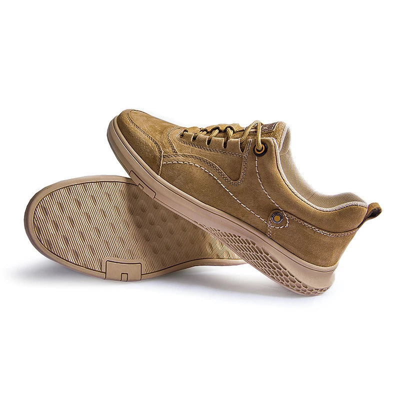 Pair of tan sneakers on a white background