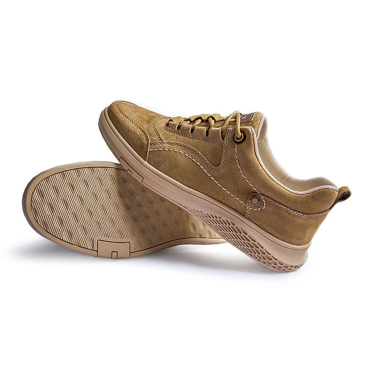 Pair of tan sneakers on a white background