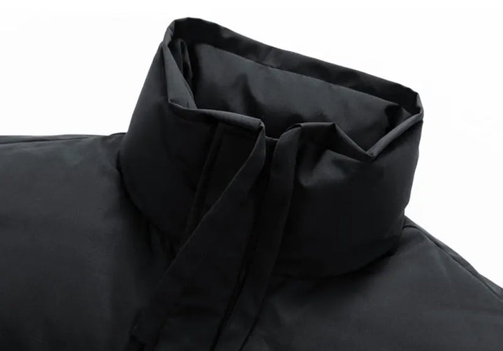 Close-up of a black hooded garment on a white background