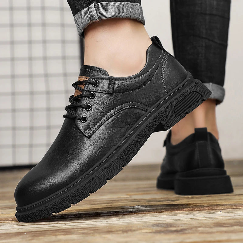 Black leather shoes on a wooden floor with a neutral background