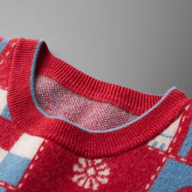 Close-up of a red sweater with a patterned design on a gray background