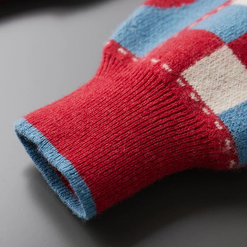 Close-up of a red, blue, and white checkered sock on a gray surface