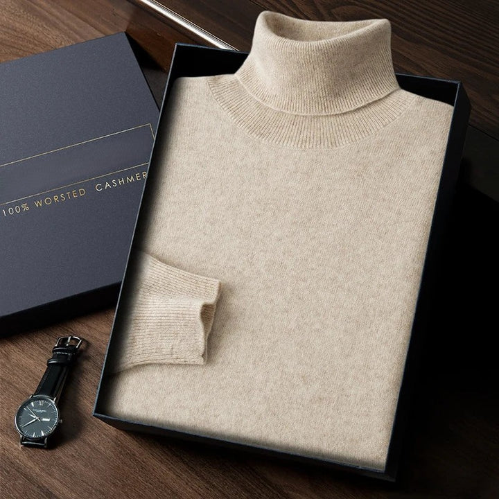 Beige turtleneck sweater in a box with a watch on a wooden surface