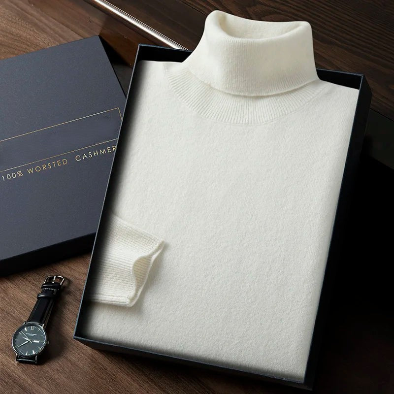 White turtleneck sweater in a box with a watch on a wooden surface