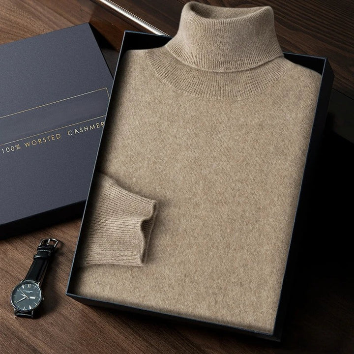 Beige turtleneck sweater in a box with a watch on a wooden surface