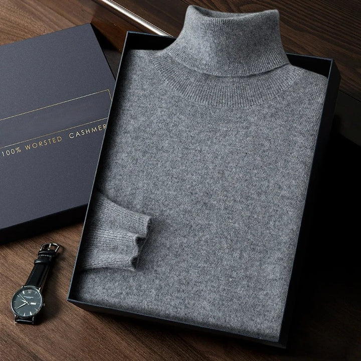 Gray turtleneck sweater in a box with a watch on a wooden surface