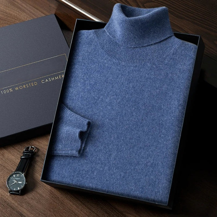 Blue turtleneck sweater in a box with a watch on a wooden surface
