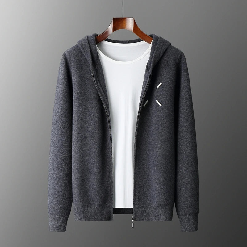 Gray hoodie with a zipper on a wooden hanger against a gray background