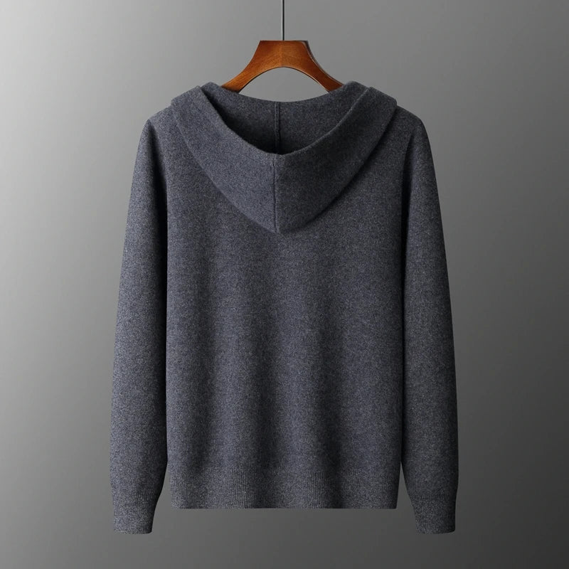 Gray hoodie on a wooden hanger against a gray background