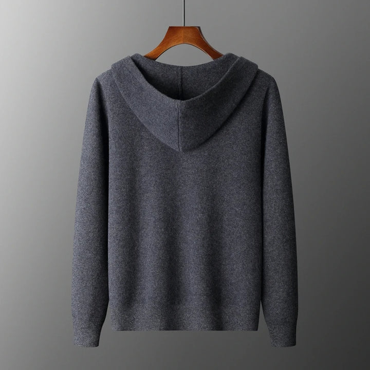 Gray hoodie on a wooden hanger against a gray background