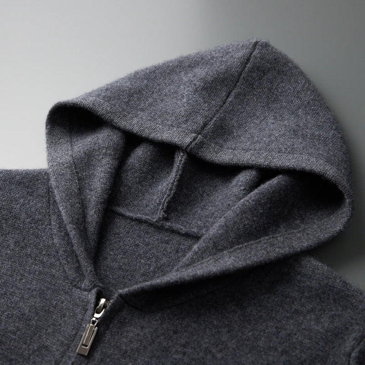 Close-up of a gray hoodie with a zipper on a light gray background