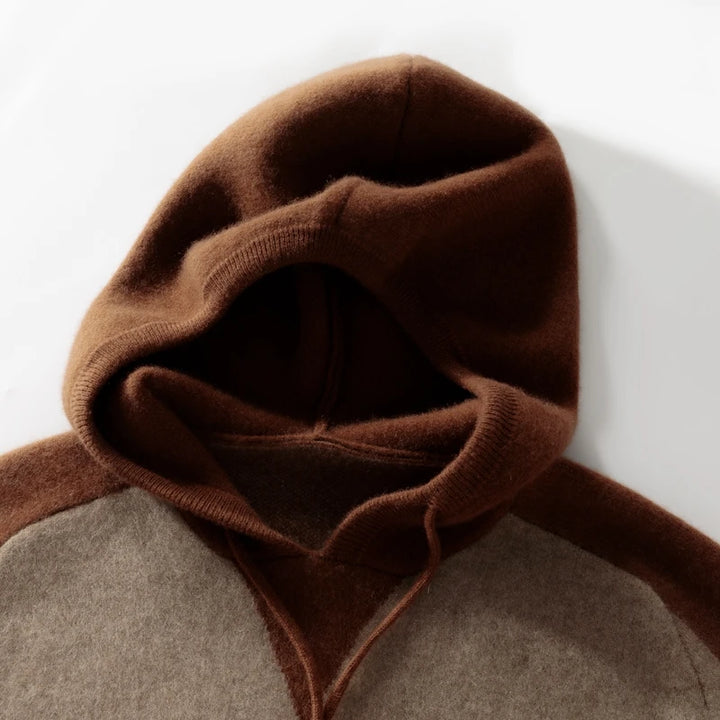 Close-up of a brown and gray garment with a hood on a white background