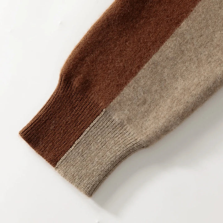 Close-up of a brown and beige sweater sleeve on a white background