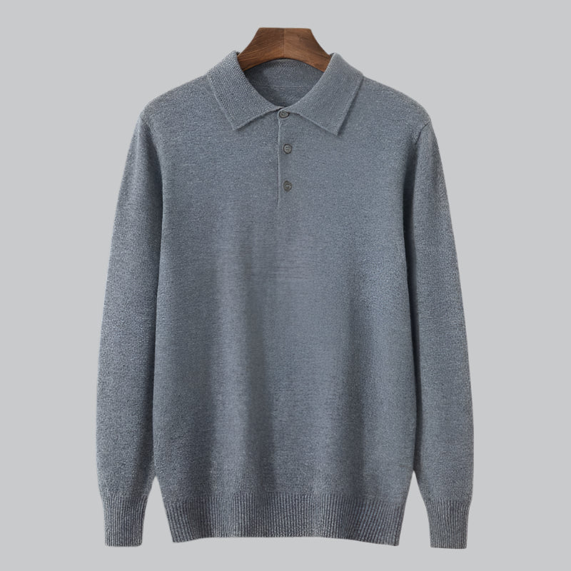 Gray sweater on a wooden hanger against a light gray background