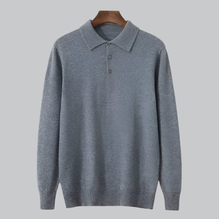 Gray sweater on a wooden hanger against a light gray background