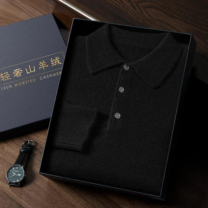 Black cashmere sweater in a box with a watch on a wooden surface